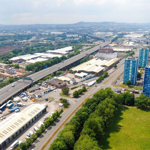 An overview of the viaduct and multi-lane highway through an industrial area.